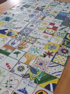 Team-building workshop with participants painting traditional Portuguese tiles in Lisbon