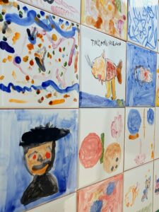 Young participants creating colorful Portuguese tiles in a hotel-based holiday workshop