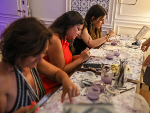 Corporate team painting traditional Portuguese tiles at a hotel in Lisbon during a bespoke DMC-organized workshop