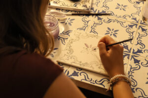 Customized cultural activity: attendees designing and painting Portuguese tiles at a DMC-arranged Lisbon hotel event