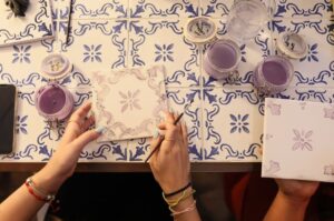 Team-building workshop with professionals painting authentic Portuguese ceramic tiles at a luxury Lisbon venue