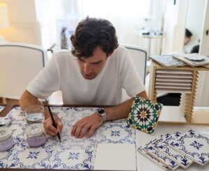 Event guests enjoying a hands-on tile painting experience at a Lisbon hotel, creating unique keepsakes
