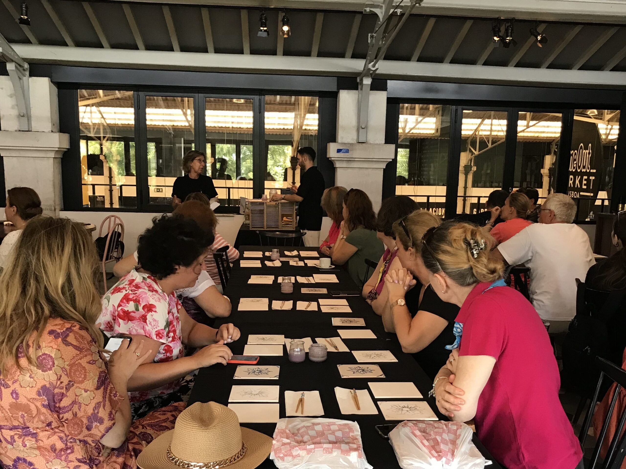 Corporate team participating in a bespoke Portuguese tile painting workshop at a luxury hotel in Lisbon